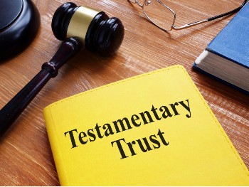 Testamentary Trust booklet and gavel on lawyer’s desk