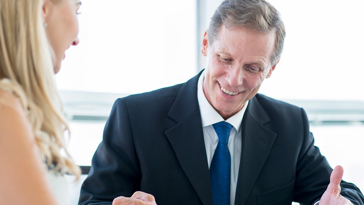 Smiling attorney advising client on personal representative duties during the Florida probate process.