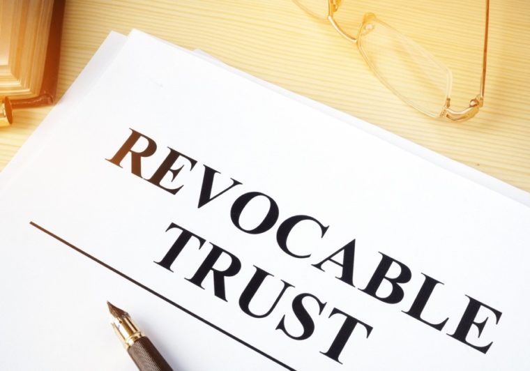 Revocable trust document with pen and reading glasses